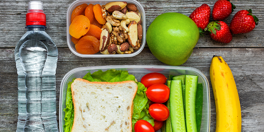 Healthy lunch boxes with sandwich and bottle of water