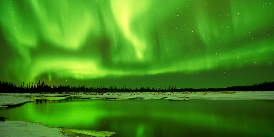 Northern Lights reflections in lake in Fairbanks Alaska