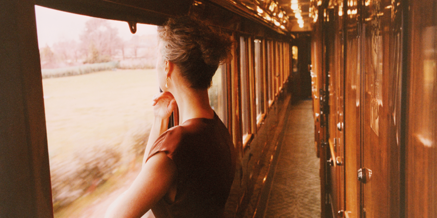 A woman looks out of the window of the Venice Simplon-Orient-Express.